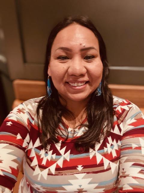 Headshot of Sarah Young Bear-Brown/tti-Ks-mi-ge-a wearing a multi-colored top